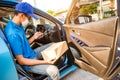 Asian delivery man wearing mask protect covid-19 virus and stocktaking checklist with amount of parcels Royalty Free Stock Photo