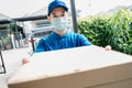 Asian Delivery man wearing mask send a pizza food on front home receiver shipping deliver social distancing Royalty Free Stock Photo