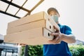 Asian Delivery man wearing mask send a pizza food on front home receiver shipping deliver social distancing Royalty Free Stock Photo