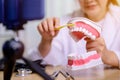 Asian dentist woman working online at home. Recording blog video for tutorial instructional brushing teeth clean.