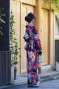 Asian Destinations. Full Length Portrait of Young Female Geisha in Traditional Japanese Kimono in Kyoto City, Japan