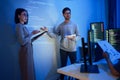 asian developer leads present code review session, pointing at code projected on the wall with colleagues teamwork and knowledge