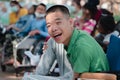 Asian disabled child on wheelchair is playing learning and exercise in the outdoor park with friends