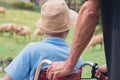 Asian disabled child on wheelchair wearing a hat in the sheep farm