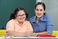 Asian disabled children Or, an autistic child learns to read, write and train their hand and finger muscles with a teacher at