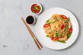 Asian dish of fried rice noodles with shrimp and vegetables. The view from the top. Copy-space. Royalty Free Stock Photo