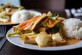 Asian dishes with curry tofu and chicken during lunch break