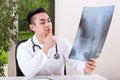 Asian doctor analysing X-ray