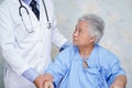 Asian doctor care, help and support senior or elderly old lady woman patient at hospital ward Royalty Free Stock Photo