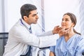 Asian doctor check-up pretty patient for her Thyroid hormones healthy at hospital or medical clinic