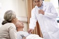 Asian doctor checking senior patient using stethoscope Royalty Free Stock Photo