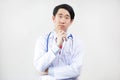 Asian doctor in lab coat think in white background Royalty Free Stock Photo