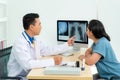 Asian doctor man medical diagnosis of lungs and reported bad news for cancer. Patient listening x-ray scan results from doctor at Royalty Free Stock Photo