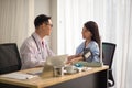 Asian Doctor and patient talking and checking health care medical sickness at hospital