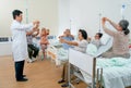 Asian doctor show and present the method to exercise hand and wrist to senior people in clinic or hospital