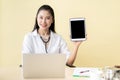 Asian doctor showing a tablet. Royalty Free Stock Photo