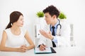 Asian doctor talking with female patient Royalty Free Stock Photo