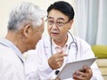 Asian doctor talking to patient