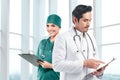 Asian doctor team with stethoscope holding a clipboard Royalty Free Stock Photo