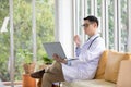 Doctor using laptop computer and thinking something