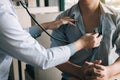 Asian doctor is using a stethoscope listen to the heartbeat of the elderly patient Royalty Free Stock Photo