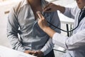 Asian doctor is using a stethoscope listen to the heartbeat of the elderly patient Royalty Free Stock Photo