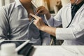 Asian doctor is using a stethoscope listen to the heartbeat of the elderly patient Royalty Free Stock Photo