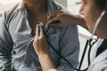 Asian doctor is using a stethoscope listen to the heartbeat of the elderly patient Royalty Free Stock Photo