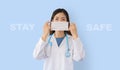 Asian doctor wearing a protective mask with `stay safe` text message Royalty Free Stock Photo