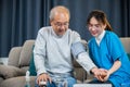 Asian doctor woman examine do checking old man client heart rate with pulsimeter monitor Royalty Free Stock Photo