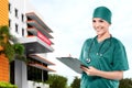 Asian Doctor woman with stethoscope holding a clipboard in front of the emergency room Royalty Free Stock Photo