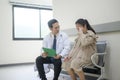 Asian Doctor is working in hospital , talking with sadness woman , medical health care concept Royalty Free Stock Photo