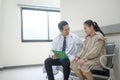 Asian Doctor is working in hospital , talking with sadness woman , medical health care concept Royalty Free Stock Photo