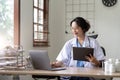 Asian doctor working with laptop in hospital and medical stethoscope, medicine on clipboard on workplace. Royalty Free Stock Photo