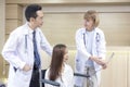 Asian doctors examine the patient`s most previous scans