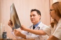 Asian doctors examining x-ray film of a patient. Royalty Free Stock Photo