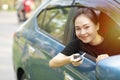 Asian driver woman smiling with new car keys Royalty Free Stock Photo