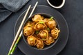 Asian dumplings in bowl, chopsticks, plates. Asian table setting. Chinese dumplings for dinner. Selective focus. Asian Royalty Free Stock Photo