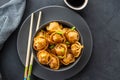 Asian dumplings in bowl, chopsticks, plates. Asian table setting. Chinese dumplings for dinner. Selective focus. Asian Royalty Free Stock Photo