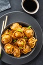 Asian dumplings in bowl, chopsticks, plates. Asian table setting. Chinese dumplings for dinner. Selective focus. Asian style Royalty Free Stock Photo