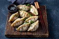Asian dumplings Gyoza potstickers on old wooden board. Top view, copy space Royalty Free Stock Photo