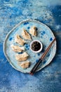 Asian dumplings with soy sauce, sesame seeds and chopsticks. Traditional chinese dim sum dumplings. Royalty Free Stock Photo