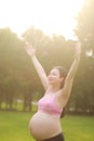 Asian Eastern Chinese happy beautiful pregnant woman hug embrace nature in forest outdoor breath fresh air enjoy peaceful life Royalty Free Stock Photo