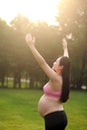 Asian Eastern Chinese happy beautiful pregnant woman hug embrace sunshine sunset sunrise nature in forest outdoor full of hope