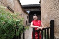 Asian Eastern oriental Chinese woman beauty in traditional ancient dress costume red cheongsam in ancient town old culture fashion Royalty Free Stock Photo