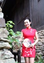 Asian Eastern oriental Chinese woman beauty in traditional ancient dress costume red cheongsam in ancient town old culture fashion Royalty Free Stock Photo