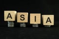 Asian economic recession, crash, collapse, crisis and Asia economy down concept. Wooden blocks in with coins Royalty Free Stock Photo