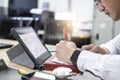 Asian education man reading books so looking tablet In office To prepare for the exam entrance to learn lesson training online