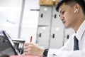 Asian education man reading books so looking tablet In office To prepare for the exam entrance to learn lesson training online