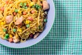 Asian egg noodles with vegetables on green tablecloth. Royalty Free Stock Photo